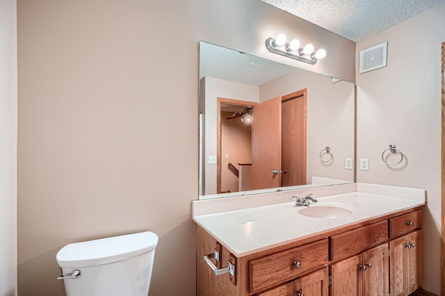 16786 Embers Ave, Lakeville, MN 55024 - bathroom featuring a textured ceiling, toilet, and vanity