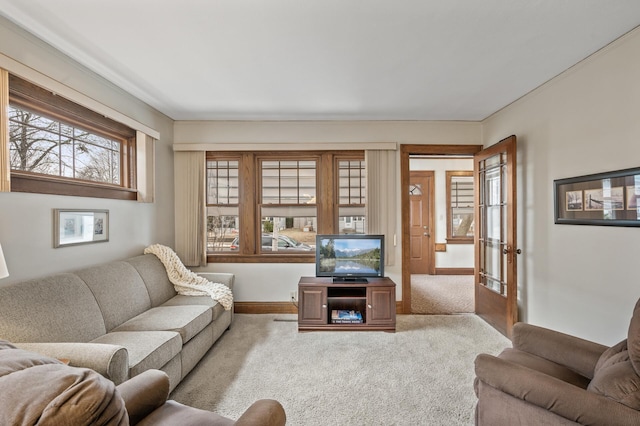 carpeted living room with baseboards