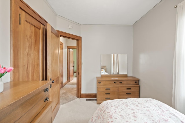 bedroom featuring baseboards and light carpet