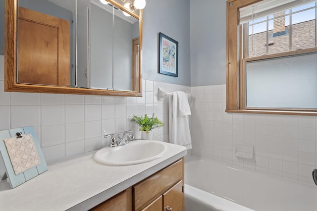 full bath with vanity and a tub to relax in