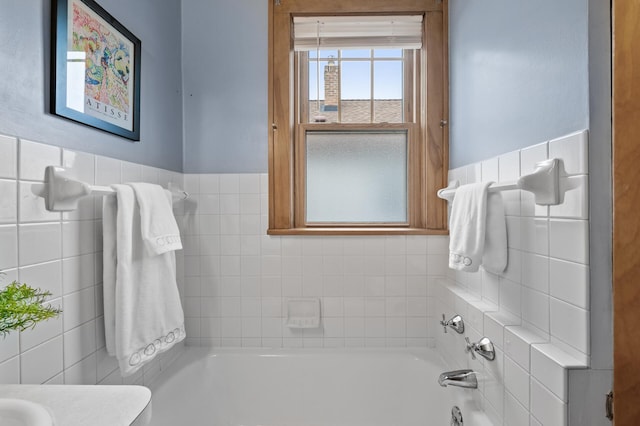 bathroom with a bathing tub and tile walls