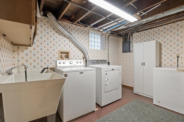 laundry room with a sink, washing machine and dryer, laundry area, and wallpapered walls