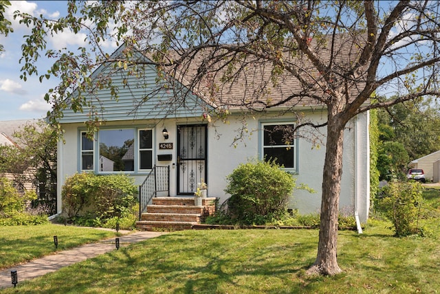 view of front of property with stucco siding and a front yard