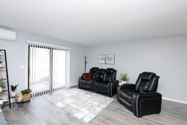 living area featuring a wall mounted air conditioner, baseboards, and wood finished floors