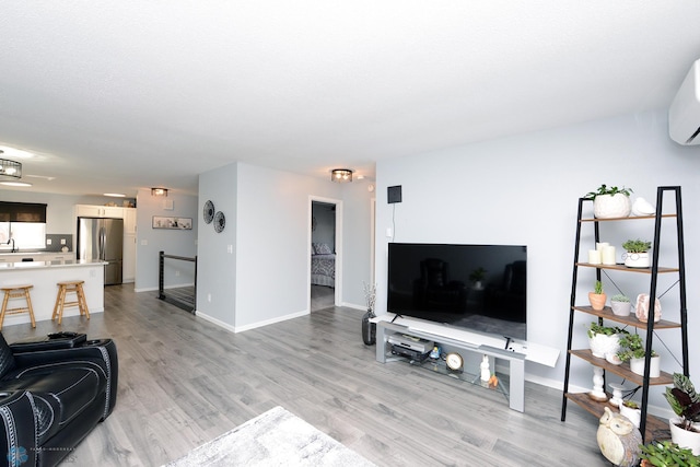 living room featuring light wood finished floors and baseboards