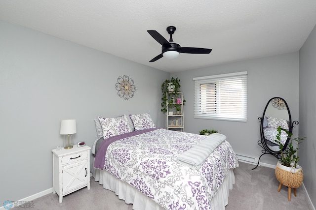 bedroom with light carpet, a textured ceiling, a ceiling fan, and baseboards