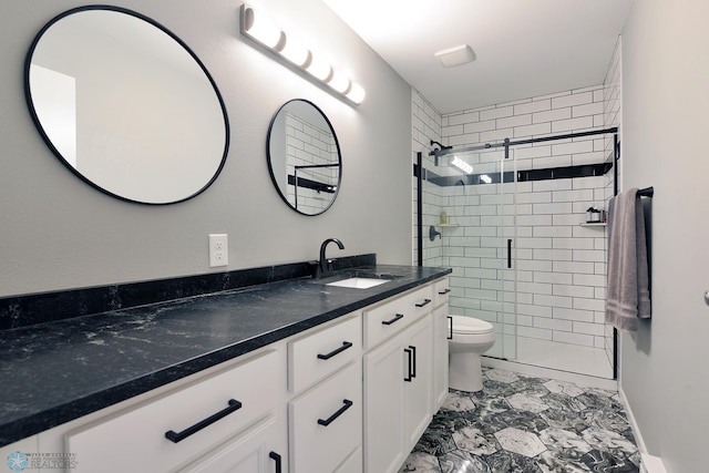 full bathroom with marble finish floor, a shower stall, toilet, and vanity