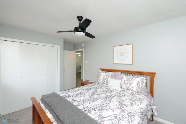 carpeted bedroom featuring a closet and a ceiling fan