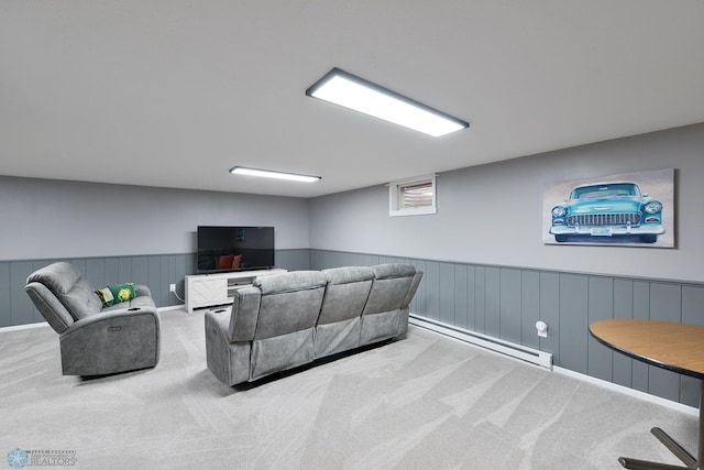 living area featuring a wainscoted wall, baseboard heating, and carpet floors