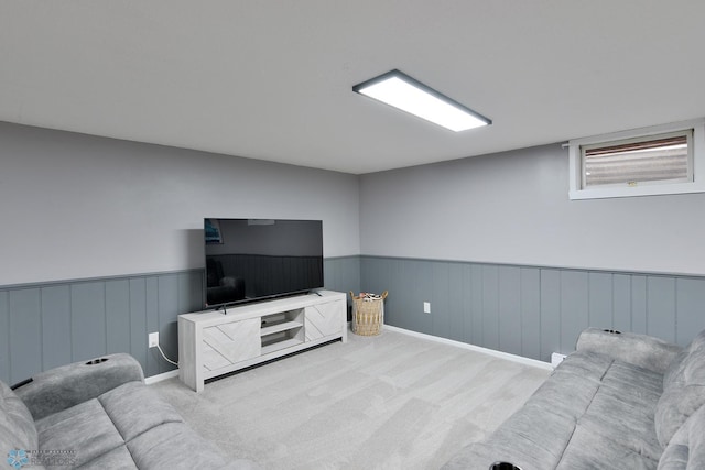 carpeted living room featuring wainscoting