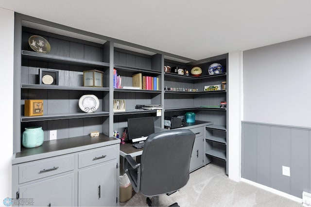 office space featuring a wainscoted wall and light carpet