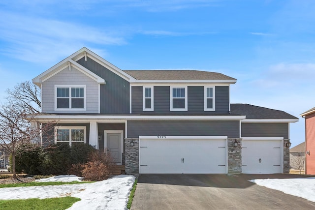 craftsman-style house with aphalt driveway and stone siding