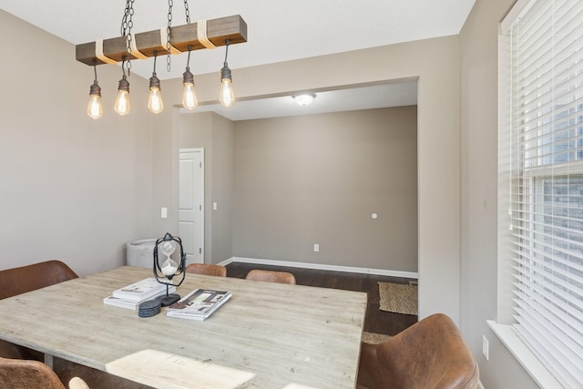 dining area featuring dark wood finished floors and baseboards