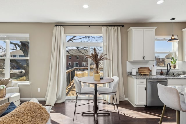 dining space with plenty of natural light, dark wood-style floors, and baseboards