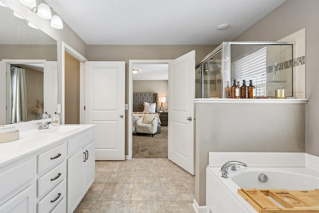 full bathroom with a shower stall, ensuite bath, a bath, tile patterned floors, and vanity