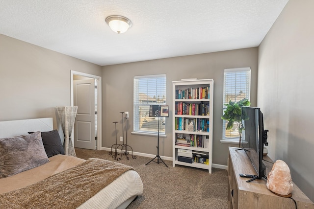 bedroom with baseboards, carpet floors, and a textured ceiling