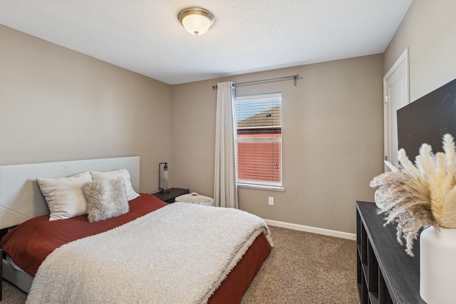 carpeted bedroom with baseboards and a textured ceiling