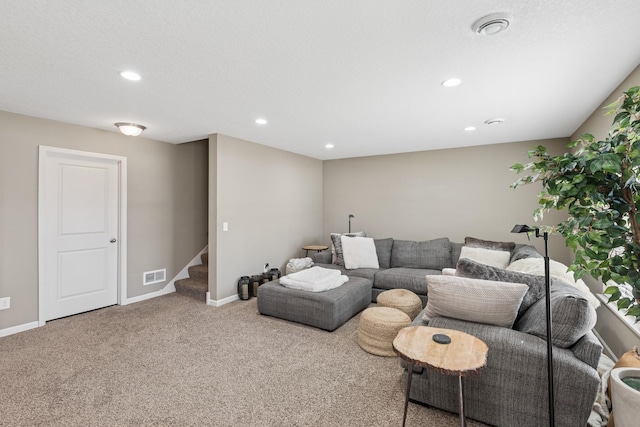 living area featuring stairs, carpet, visible vents, and baseboards