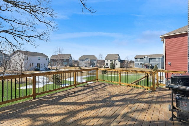 wooden terrace featuring a lawn and a residential view