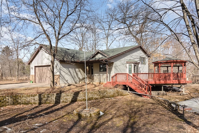 view of front of home with a gazebo, a garage, and driveway