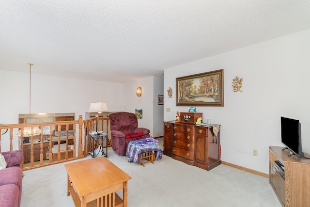 living room with baseboards, light carpet, and a textured ceiling