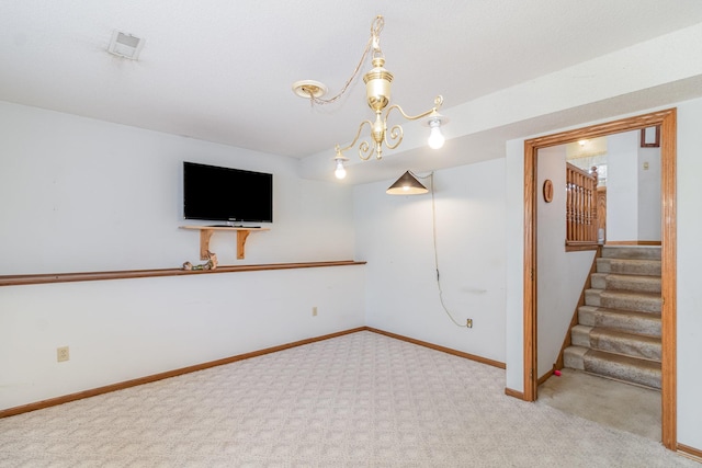 basement with baseboards, visible vents, carpet floors, stairs, and a notable chandelier