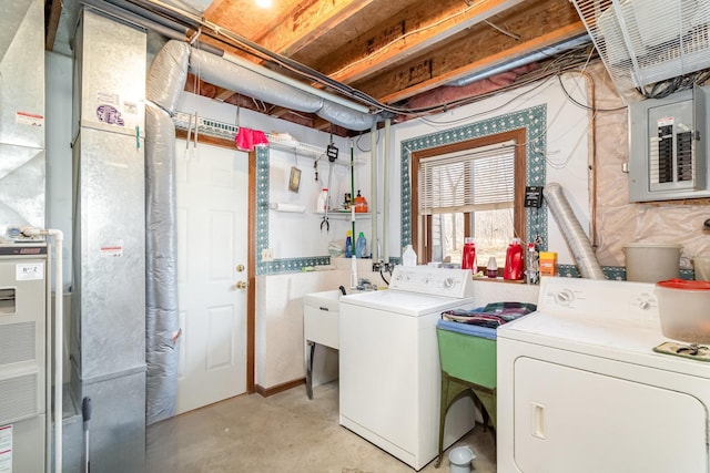 clothes washing area with washer and dryer, heating unit, electric panel, and laundry area