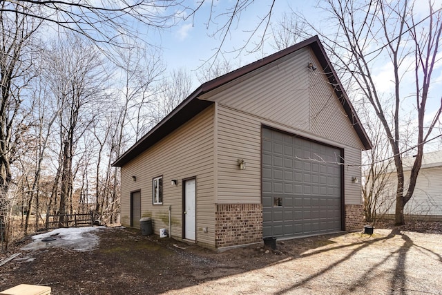 view of property exterior featuring brick siding and an outdoor structure