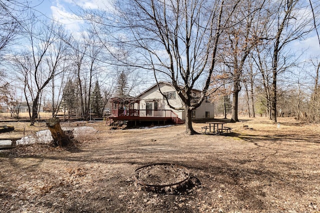 exterior space with a deck and a fire pit