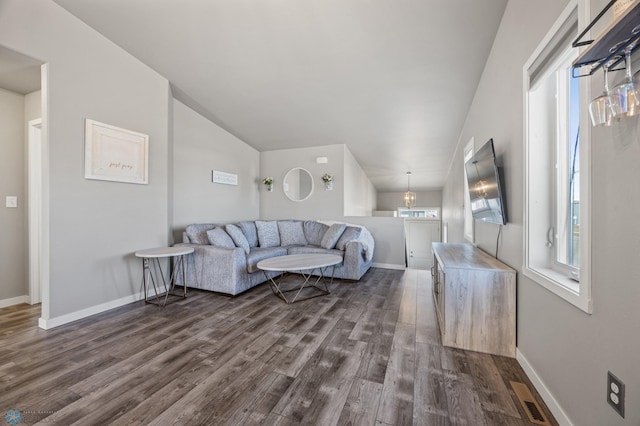 living room featuring dark wood finished floors, visible vents, and baseboards