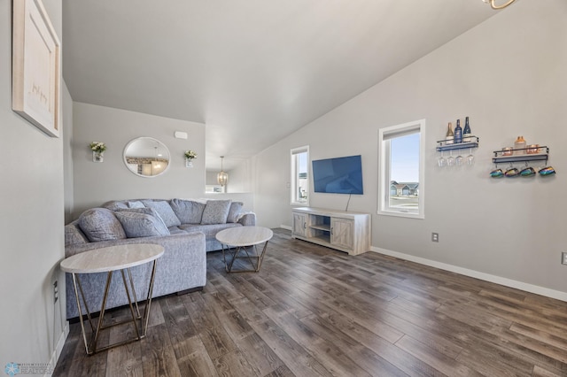 living area featuring dark wood-type flooring, baseboards, and vaulted ceiling