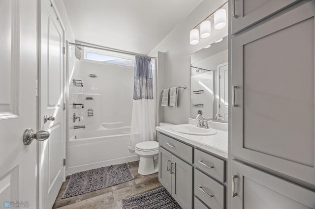 full bath featuring shower / bath combo with shower curtain, toilet, and vanity