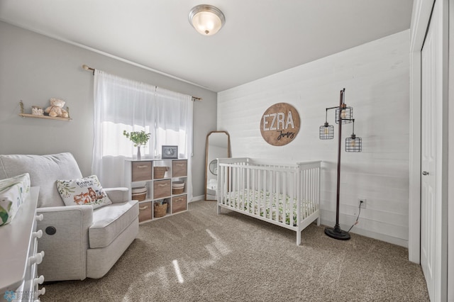 bedroom with a crib and carpet