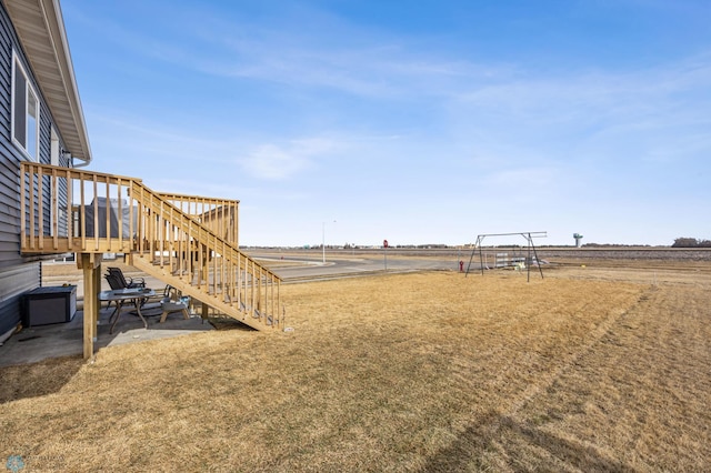 view of yard with stairway and a deck