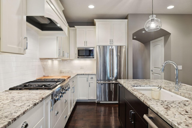 kitchen featuring a sink, appliances with stainless steel finishes, white cabinets, custom exhaust hood, and dark wood-style flooring