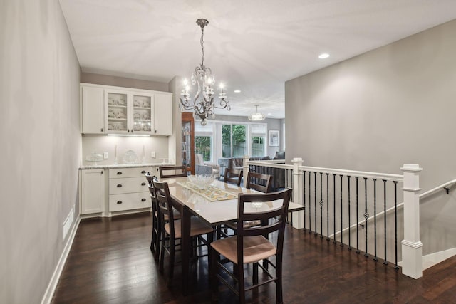 dining room featuring a chandelier, recessed lighting, dark wood-type flooring, and baseboards