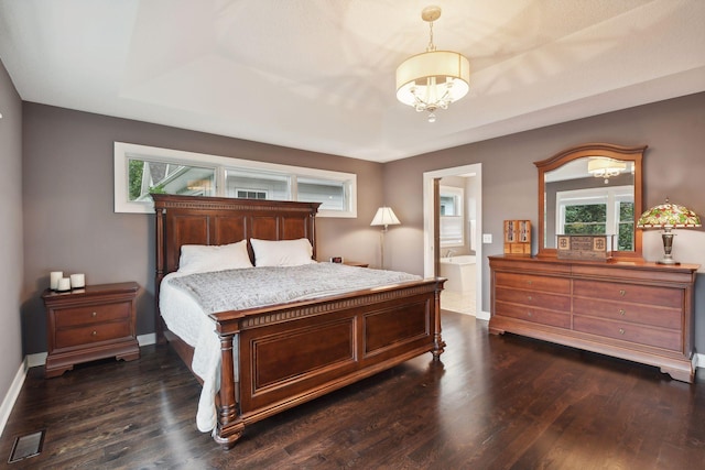 bedroom with dark wood-style floors, visible vents, and baseboards