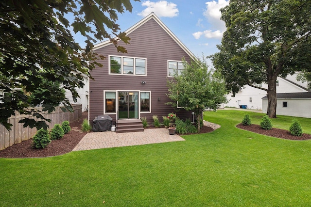 back of house with a yard, fence, entry steps, and a patio area