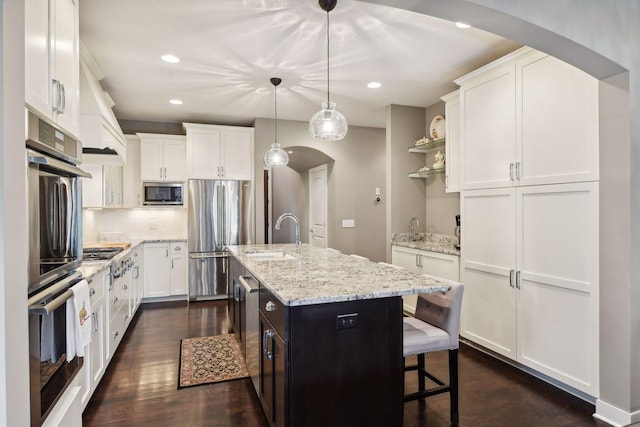 5613 Abbott Ave S, Edina, MN 55410 - kitchen featuring arched walkways, appliances with stainless steel finishes, a sink, white cabinets, and recessed lighting
