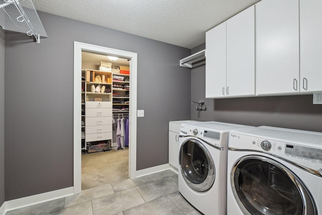 5613 Abbott Ave S, Edina, MN 55410 - laundry area featuring cabinet space, washer and clothes dryer, light tile patterned floors, a textured ceiling, and light colored carpet