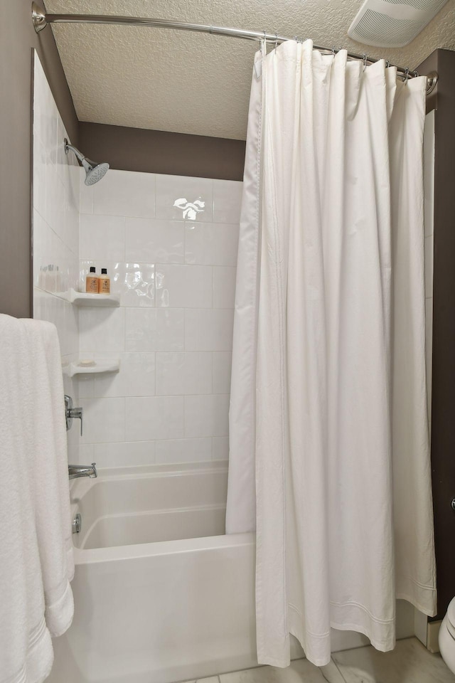 5613 Abbott Ave S, Edina, MN 55410 - full bathroom with shower / tub combo with curtain, toilet, and a textured ceiling