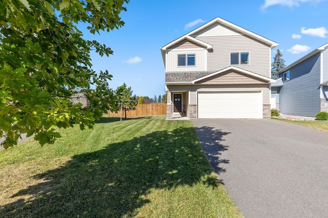 craftsman inspired home featuring board and batten siding, an attached garage, a front lawn, fence, and driveway