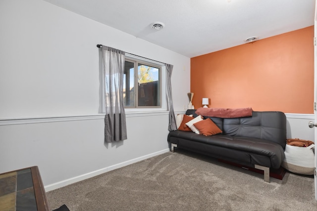 sitting room with carpet, visible vents, and baseboards