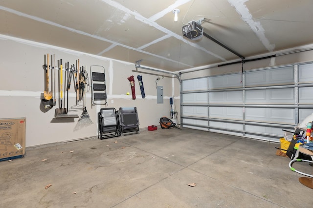 garage featuring electric panel and a garage door opener