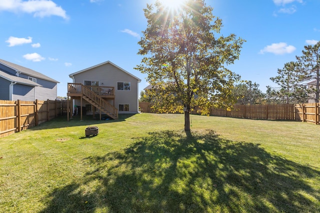 view of yard with a fenced backyard, stairway, a fire pit, and a deck