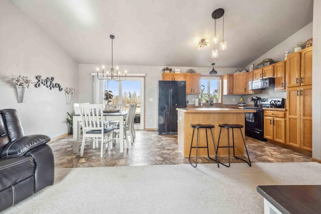 kitchen with black appliances, a kitchen island, open floor plan, carpet, and lofted ceiling