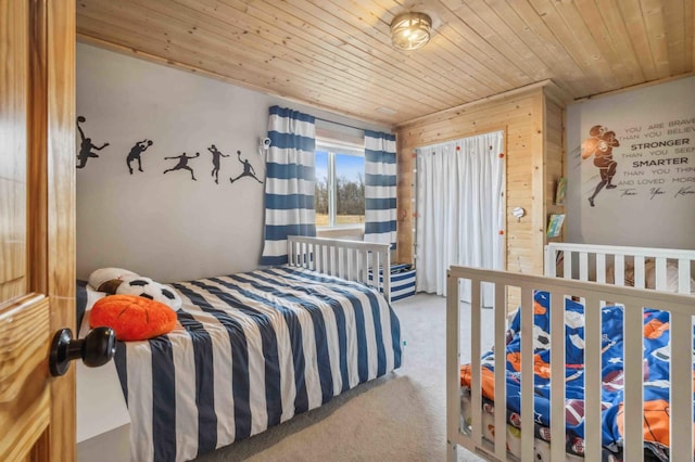 carpeted bedroom with wood ceiling