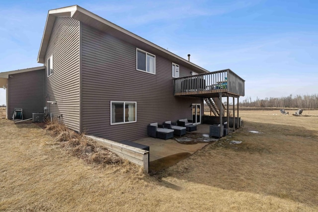 view of home's exterior featuring a deck, a patio, central AC, an outdoor hangout area, and stairs