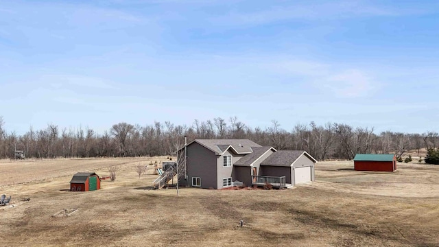 view of shed featuring a rural view and a garage