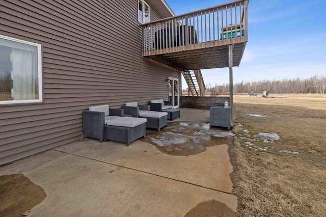 view of patio / terrace with outdoor lounge area, a deck, and stairs